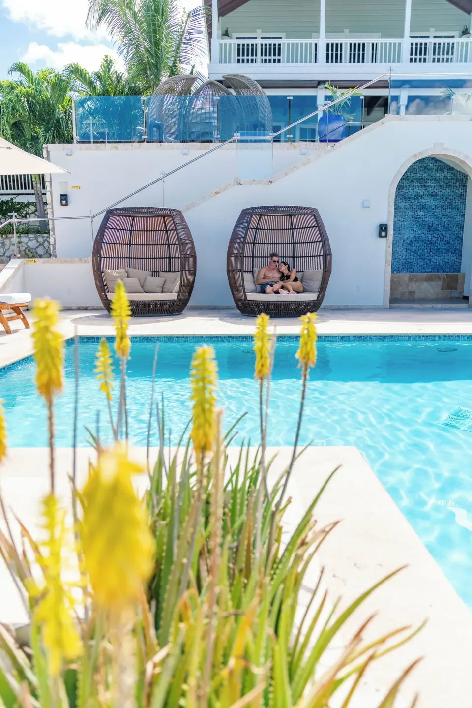 Poolside cabanas and flowering plants at Hammock Cove Antigua.