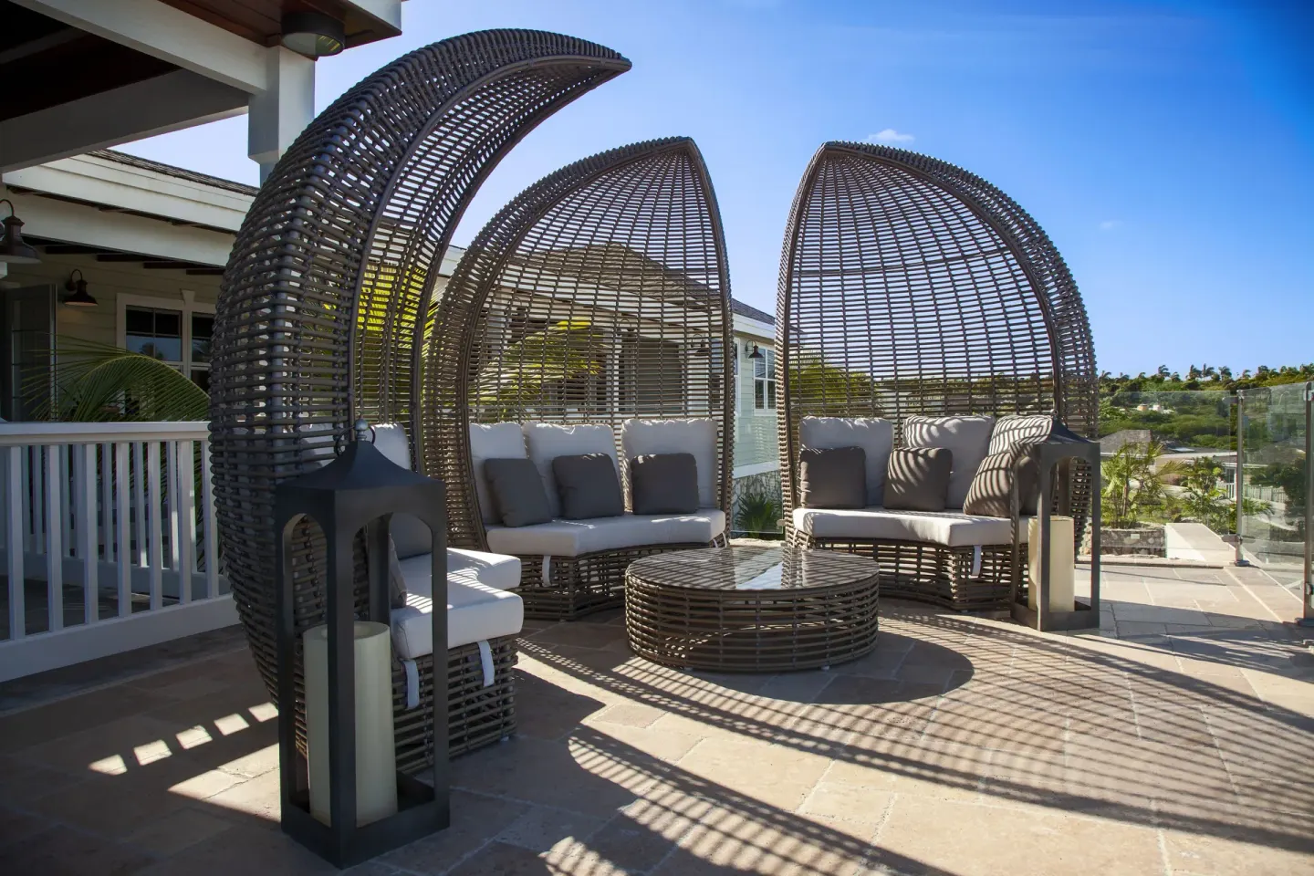 Curved wicker lounge seating on a sunny terrace at Hammock Cove Antigua.