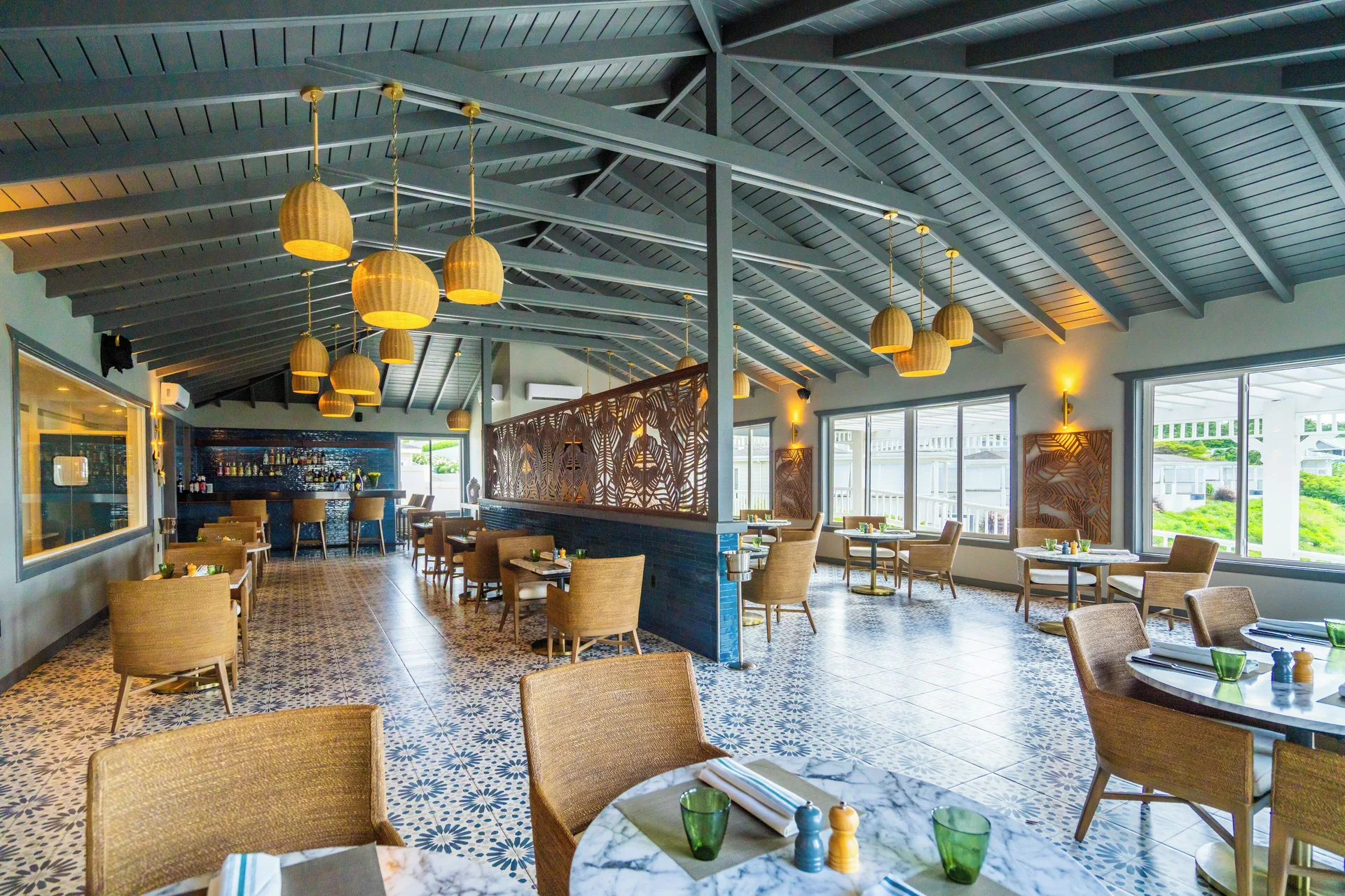Bright dining room with bar, pendant lights and patterned tile at Hammock Cove Antigua.