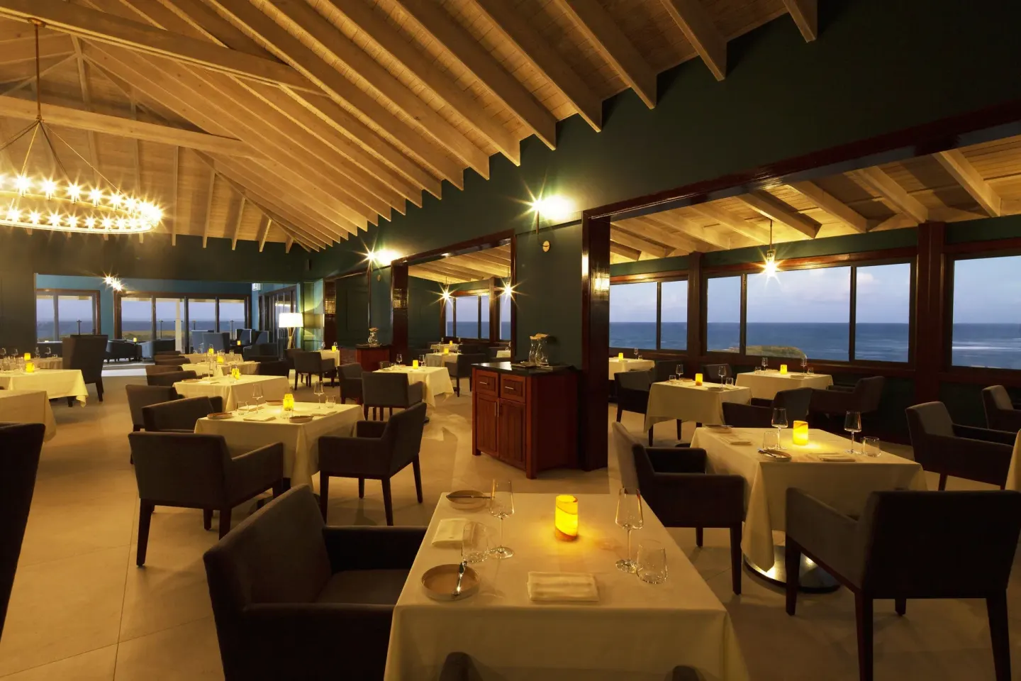 Candlelit ocean-view dining room at Hammock Cove Antigua.