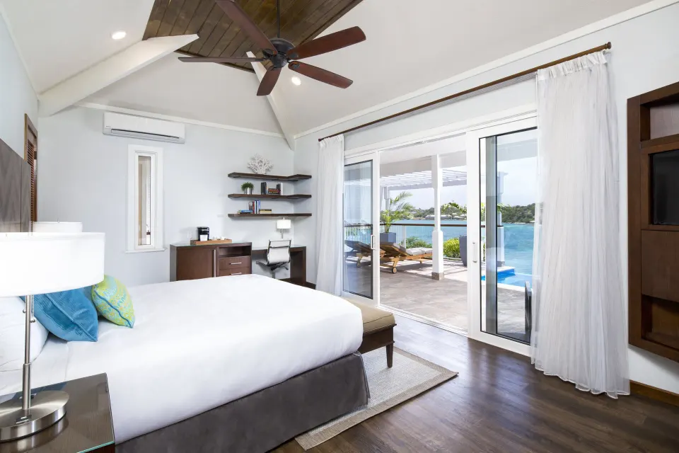 Waterfront Villa bedroom with king bed and terrace view at Hammock Cove Antigua.