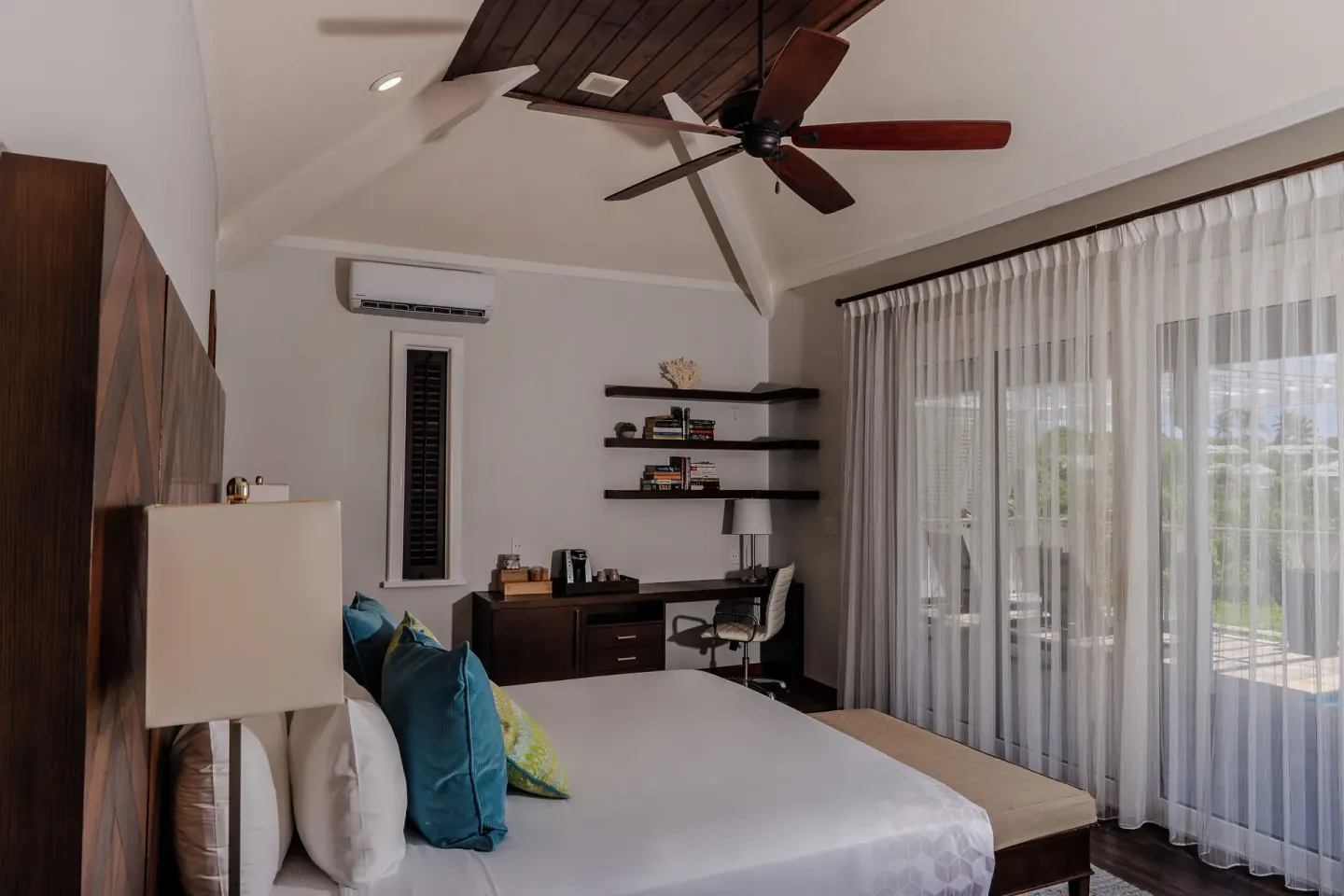 Waterview Villa bedroom with king bed, desk, shelves and glass doors at Hammock Cove Antigua.