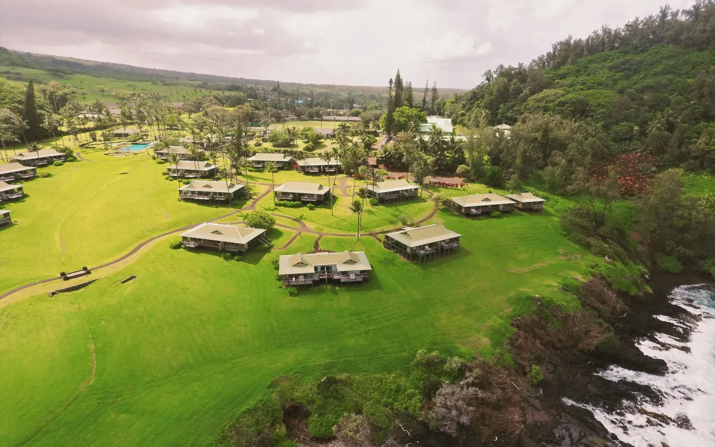 Aerial view of cottage clusters and winding paths at Hana-Maui Resort.