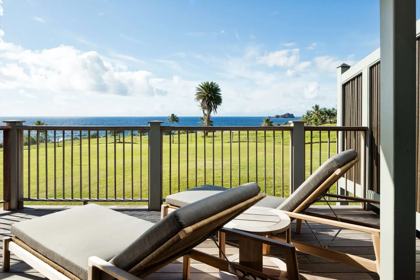 Furnished ocean-view balcony with lounge chairs at Hana-Maui Resort.