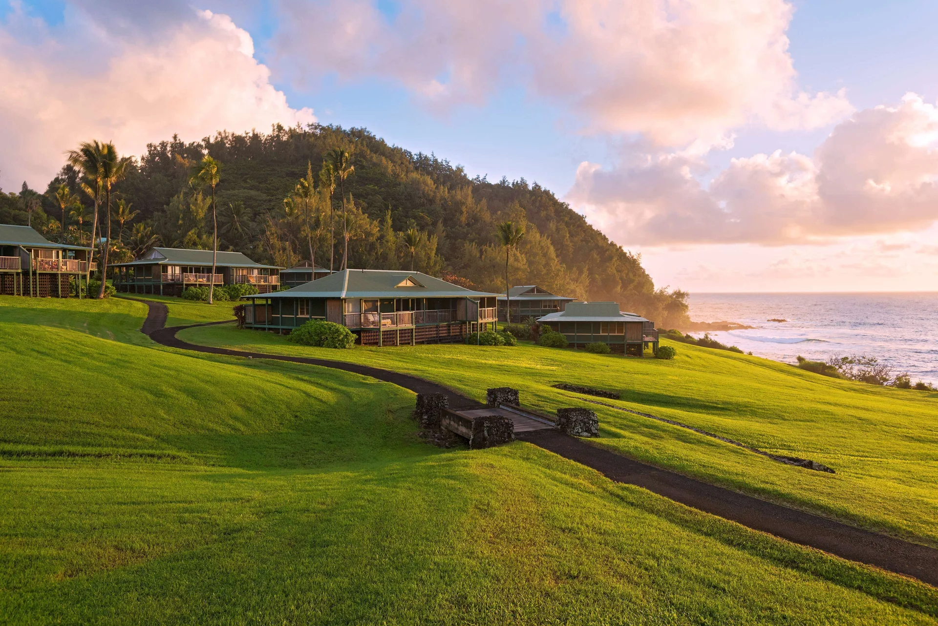 Grassy oceanfront cottages and pathways at Hana-Maui Resort.