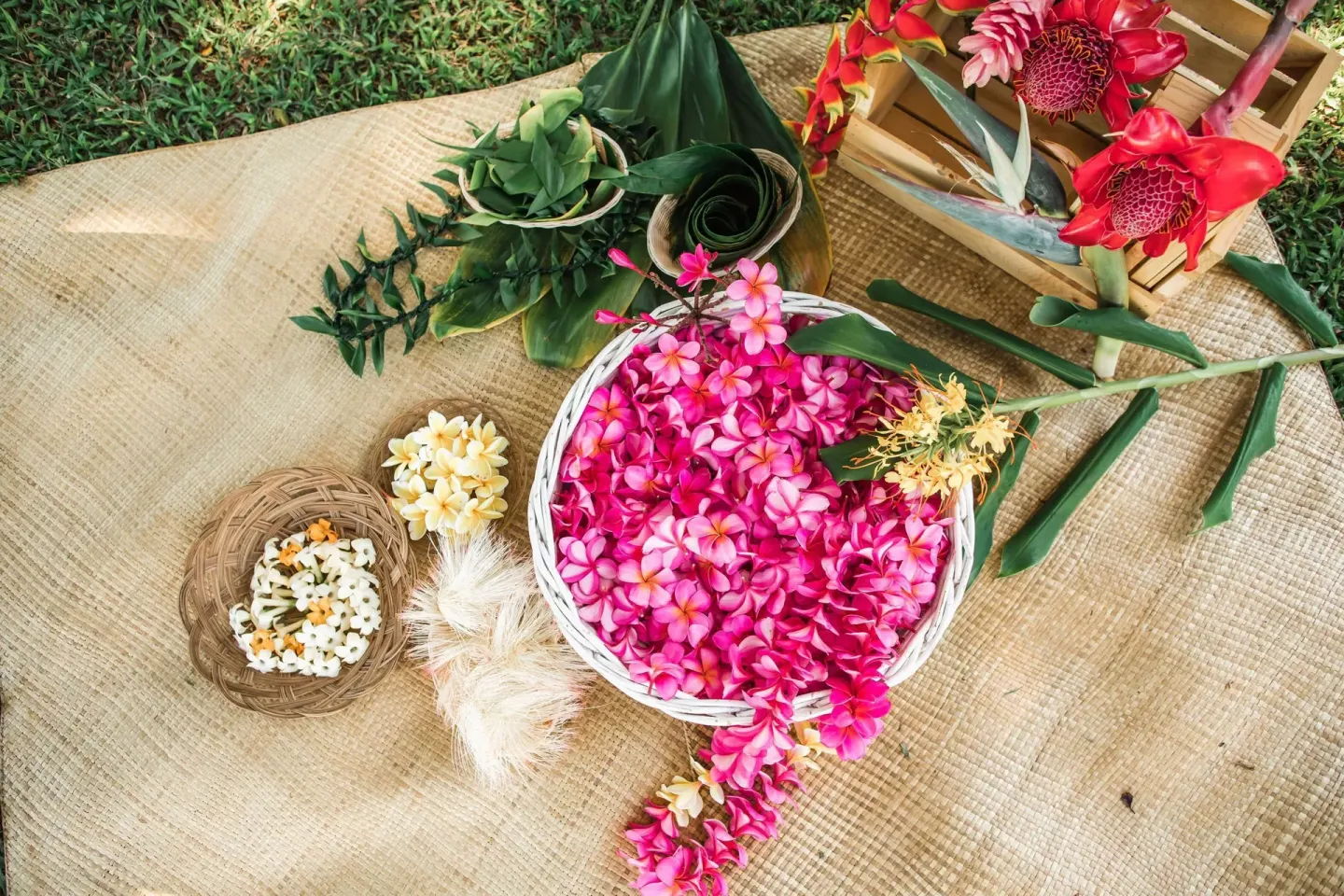 Tropical flowers and woven lei-making materials displayed at Hana-Maui Resort.