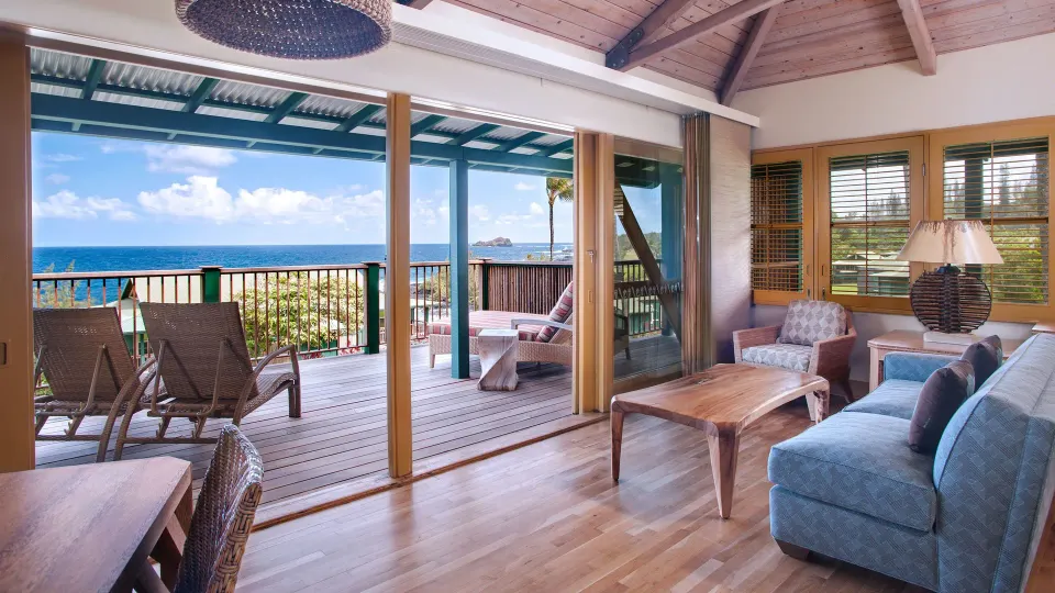 Ocean View Bungalow lounge area with open lanai doors at Hana-Maui Resort.