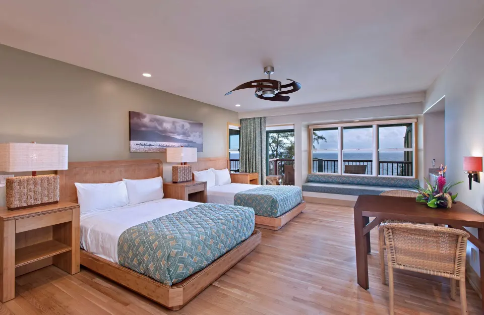 Oceanfront bungalow room with two beds and balcony view at Hana-Maui Resort.