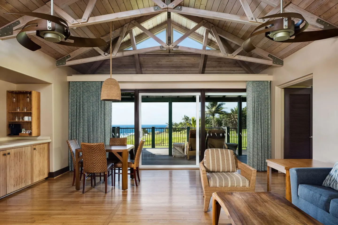 Premier Suite Oceanfront living area with dining table and lanai at Hana-Maui Resort.