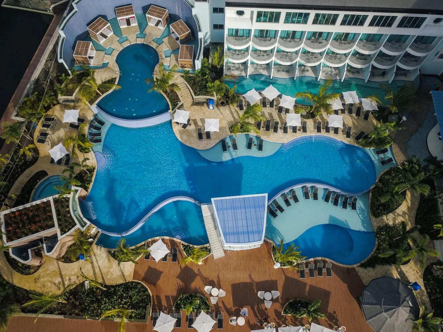 Aerial view of shaded pool areas and sun decks at Harbor Club St. Lucia.