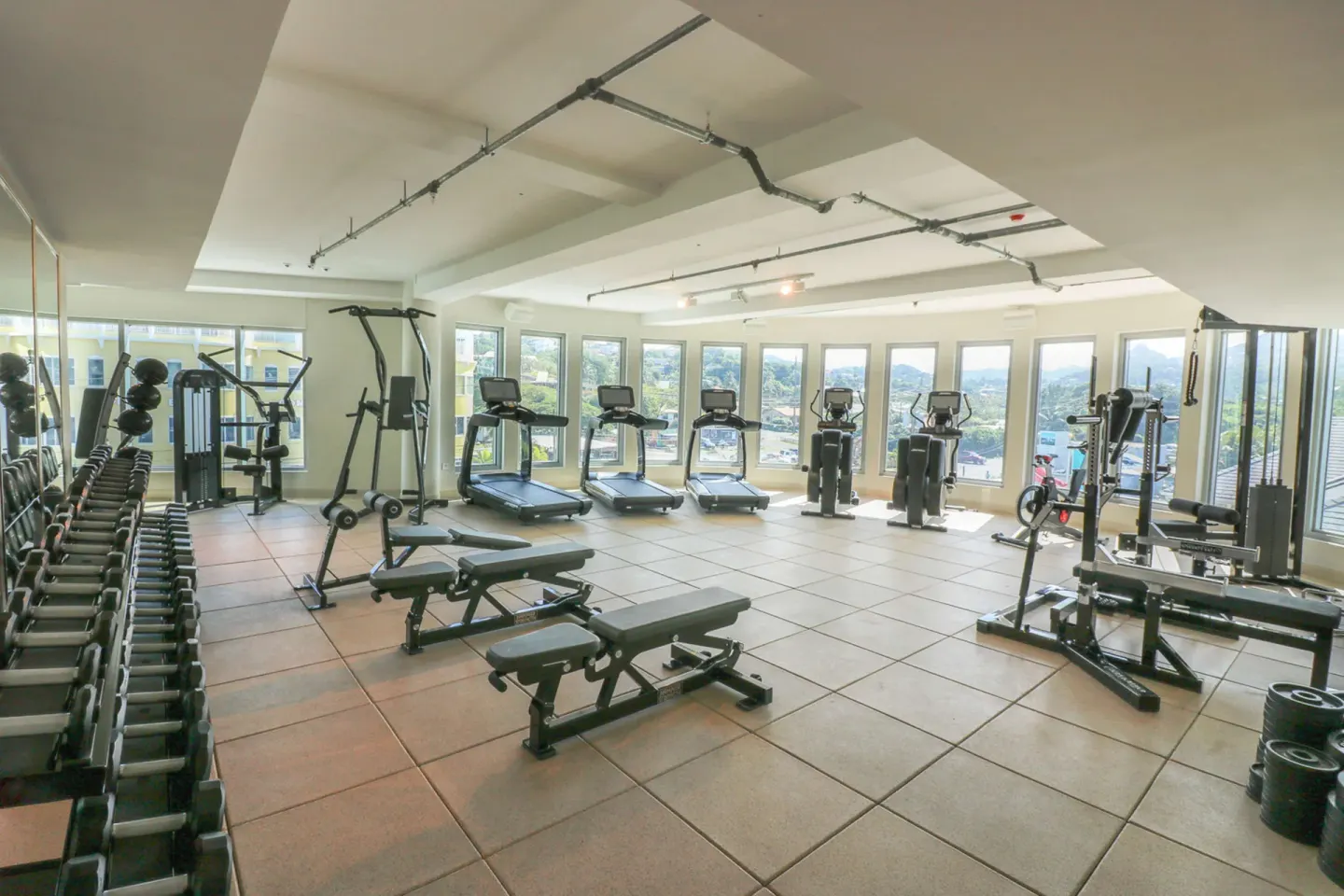 Fitness center with cardio machines and free weights at Harbor Club St. Lucia.