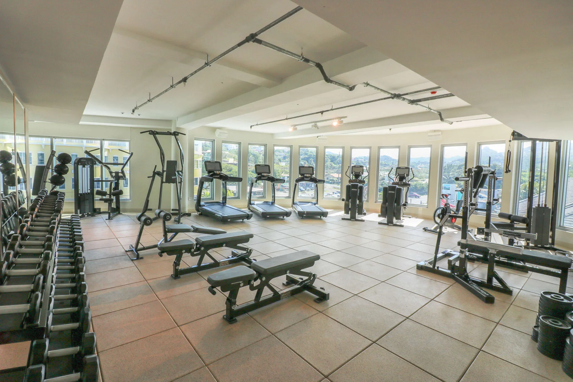 Fitness center with cardio machines and free weights at Harbor Club St. Lucia.
