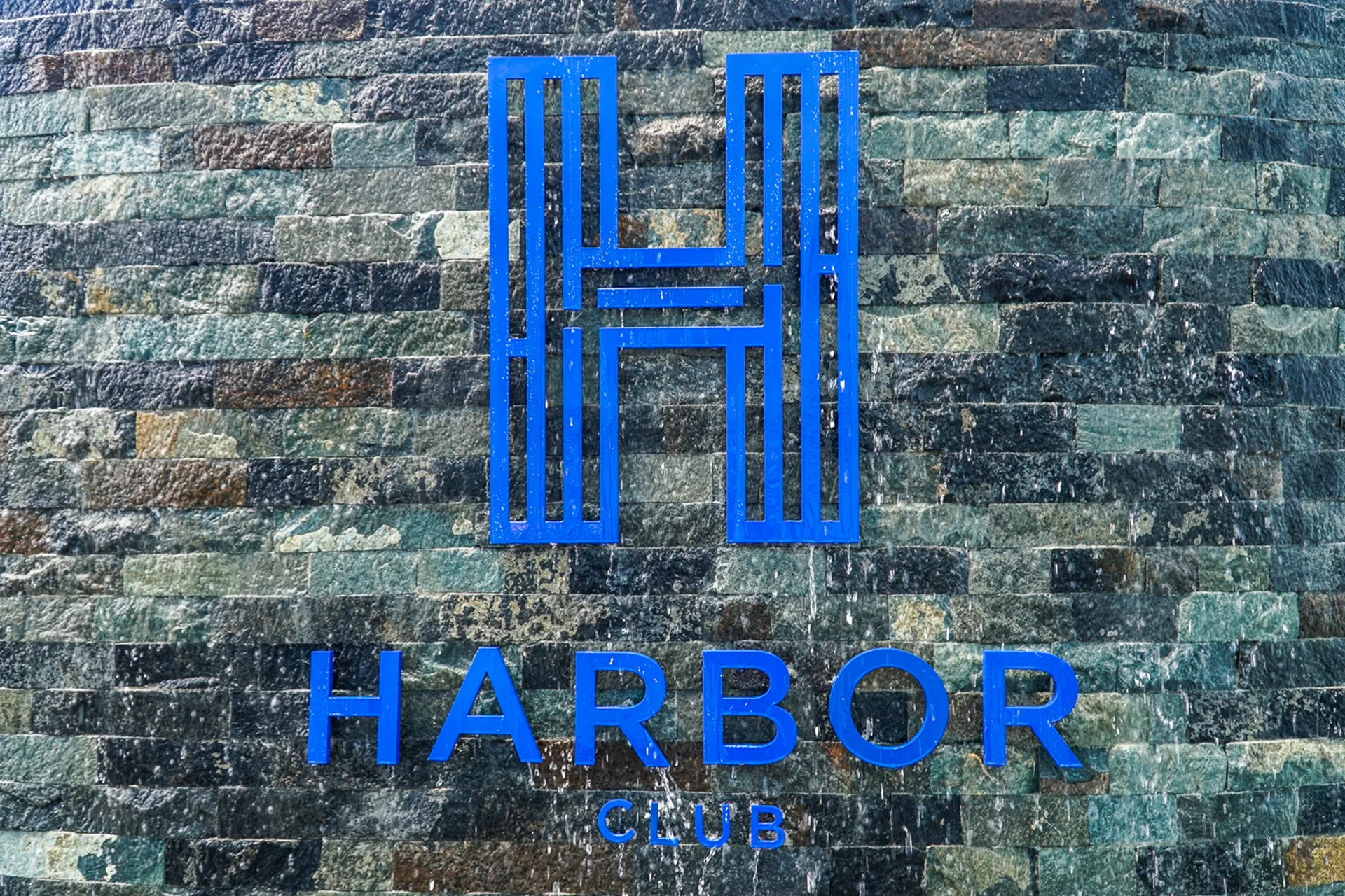 Blue Harbor Club St. Lucia logo on a stone wall at Harbor Club St. Lucia.