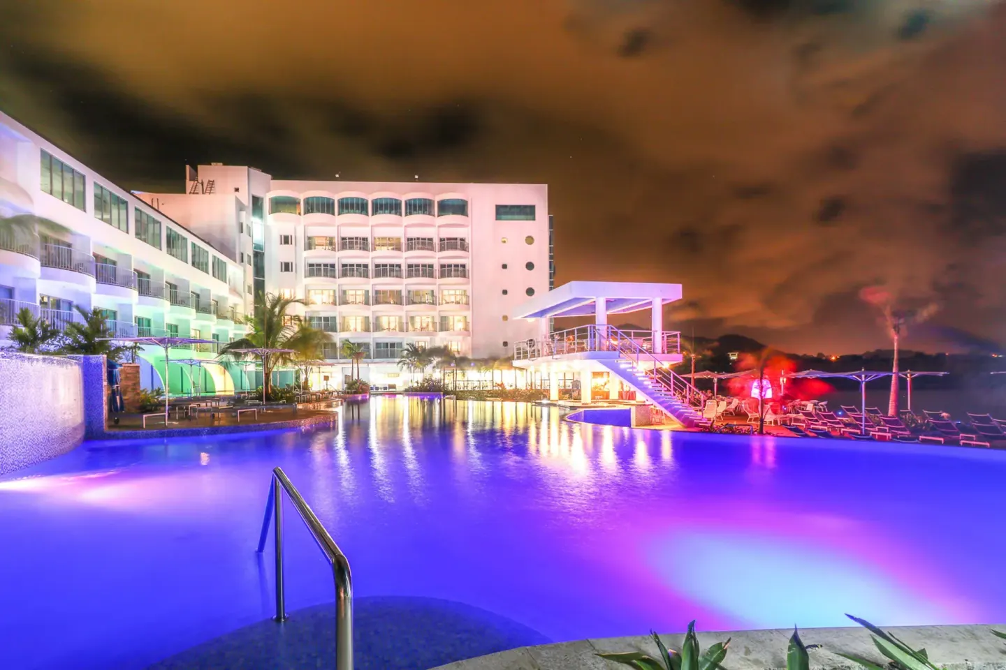 Nighttime illuminated pool and hotel exterior at Harbor Club St. Lucia.