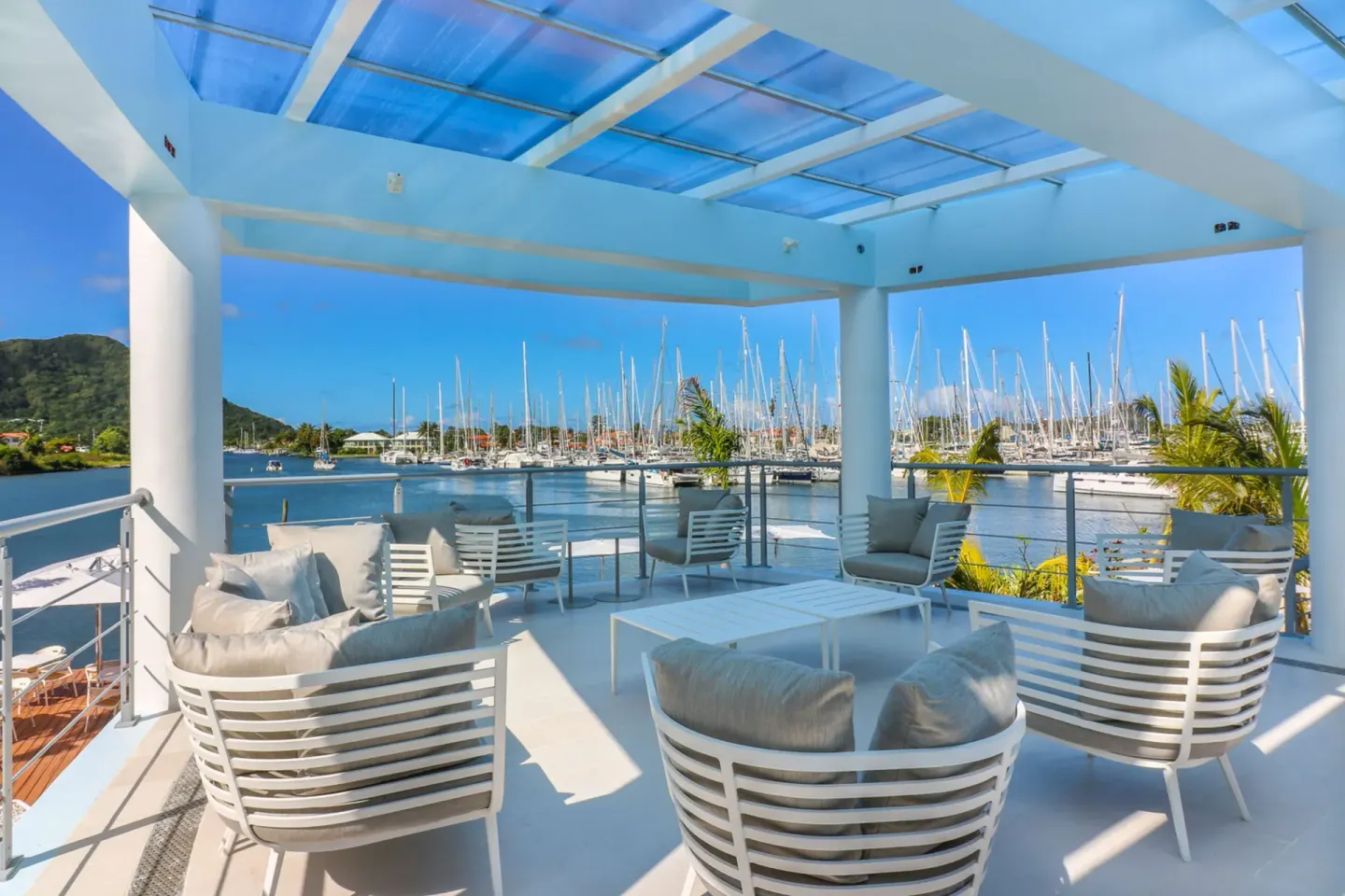 Covered marina-view terrace seating at Harbor Club St. Lucia.