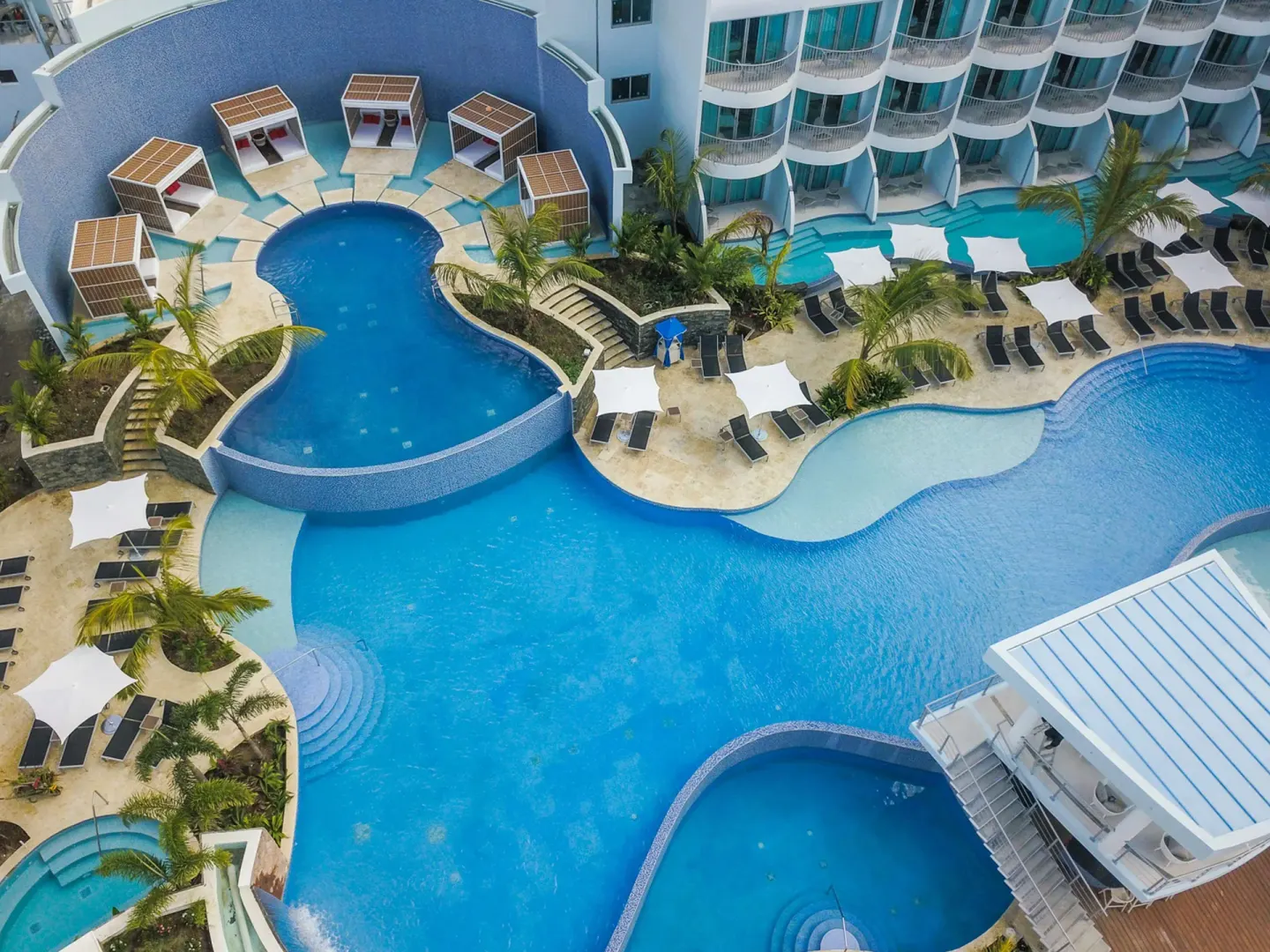 Overhead view of the main pools, cabanas, and lounge chairs at Harbor Club St. Lucia.