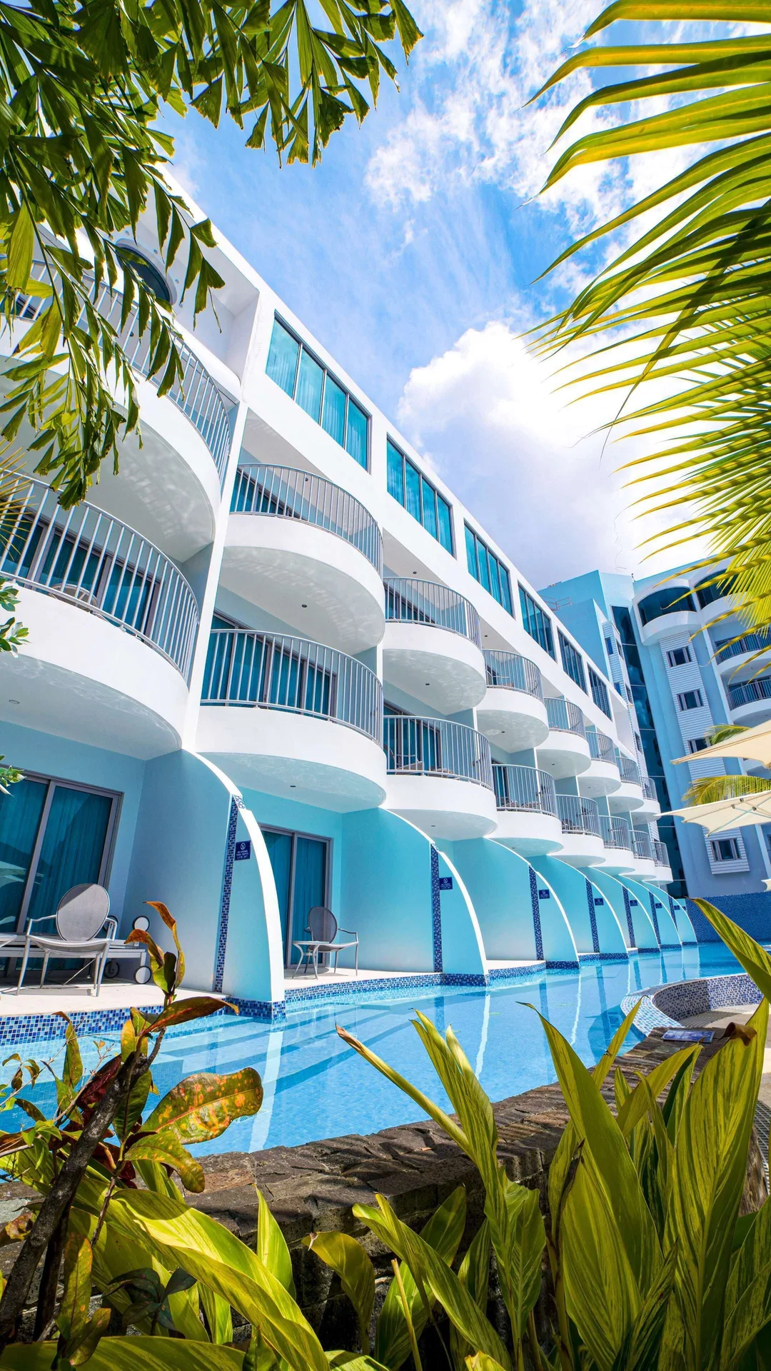 Curved balconies overlook a narrow pool at Harbor Club St. Lucia.