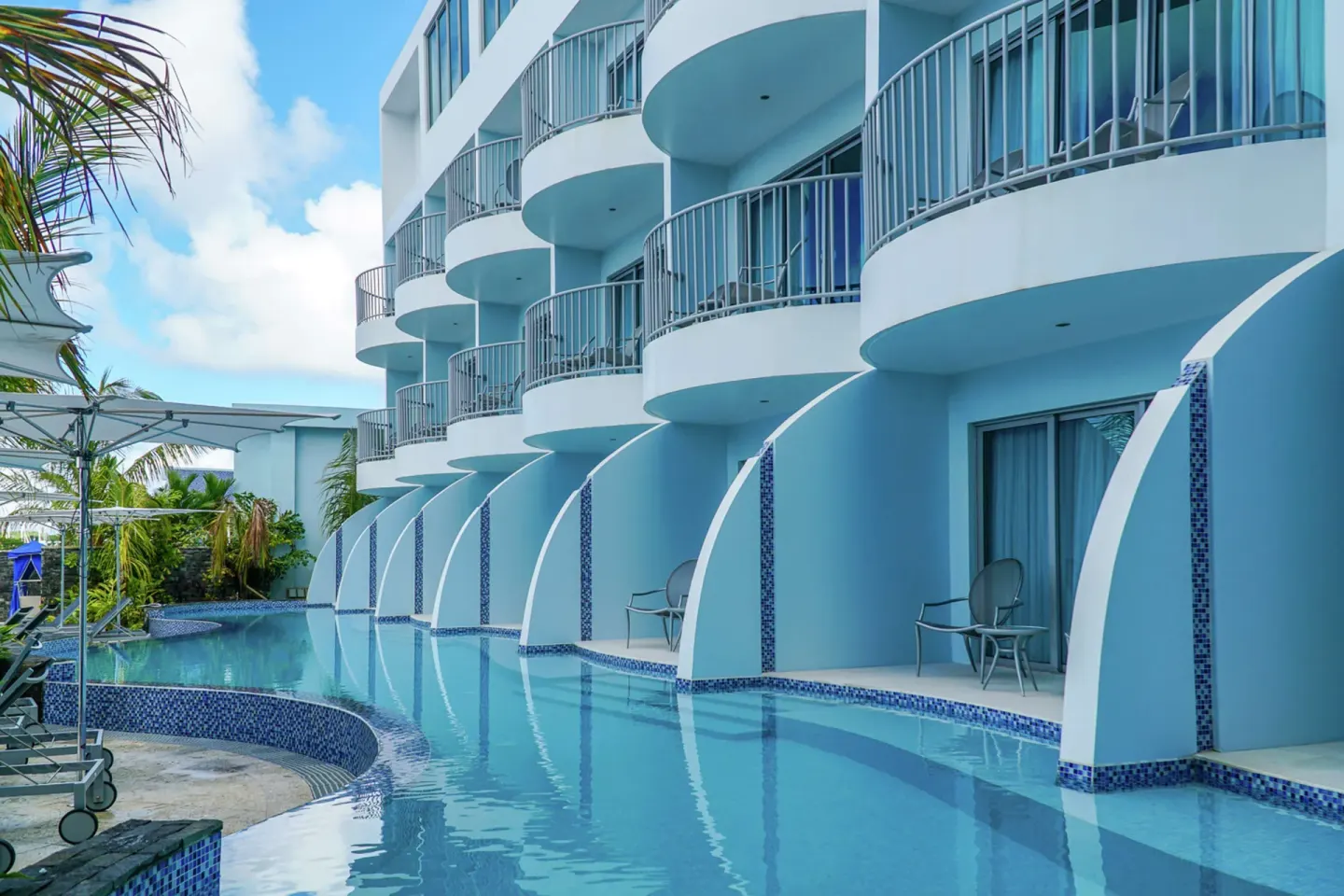 Ground-floor terraces open directly to a narrow pool at Harbor Club St. Lucia.