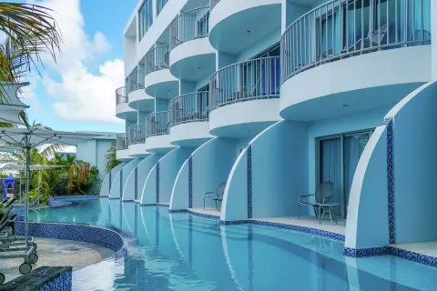 Ground-floor terraces open directly to a narrow pool at Harbor Club St. Lucia.