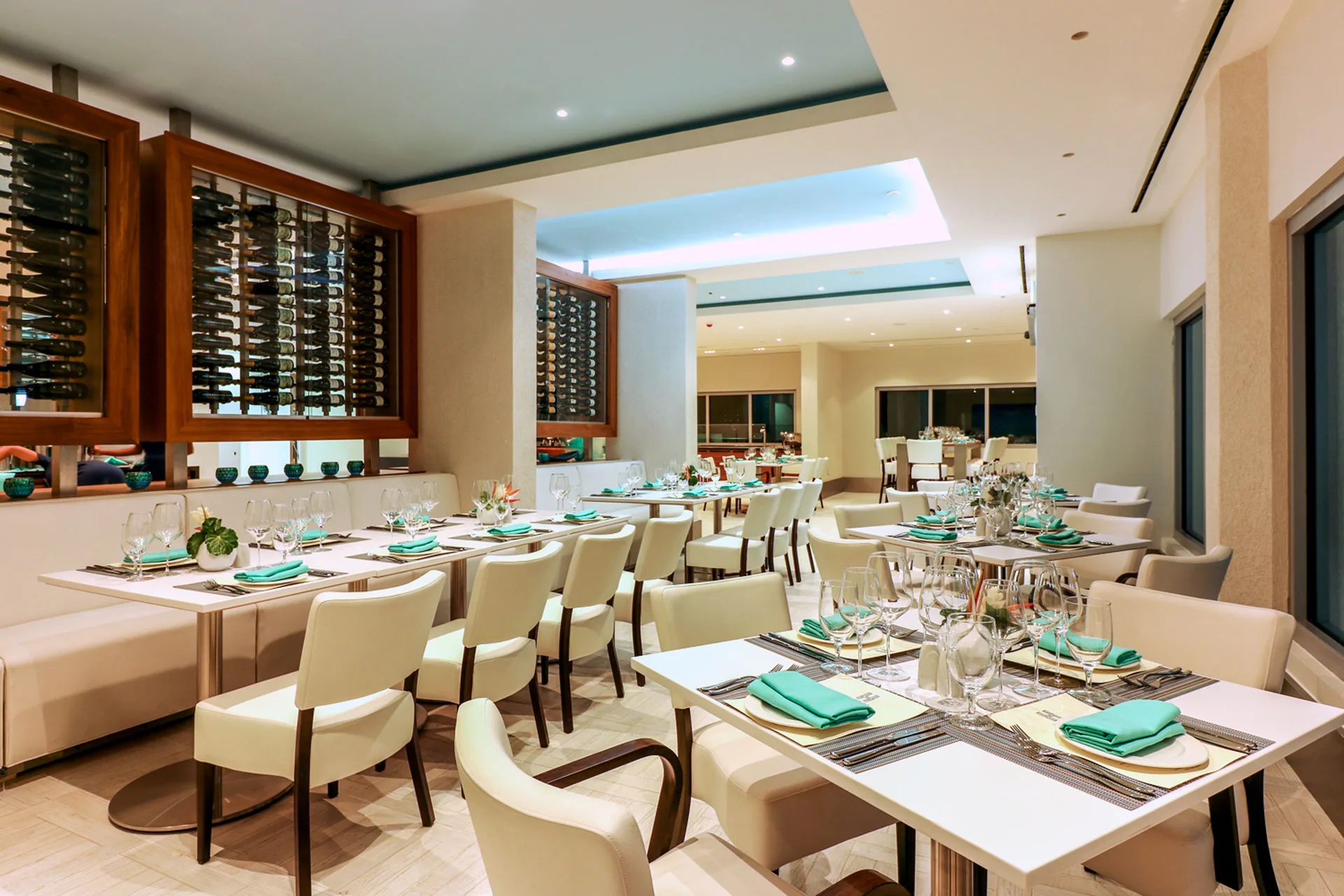 Restaurant dining room with set tables and wine displays at Harbor Club St. Lucia.