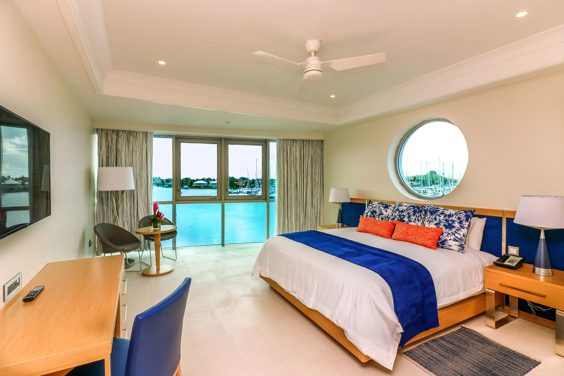 Corner Harbor Club St. Lucia with king bed, desk, TV, and harbor windows at Harbor Club St. Lucia.