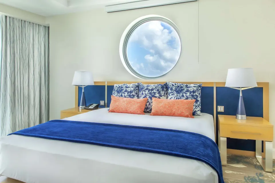 Corner Harbor Club St. Lucia bed beneath a round window at Harbor Club St. Lucia.