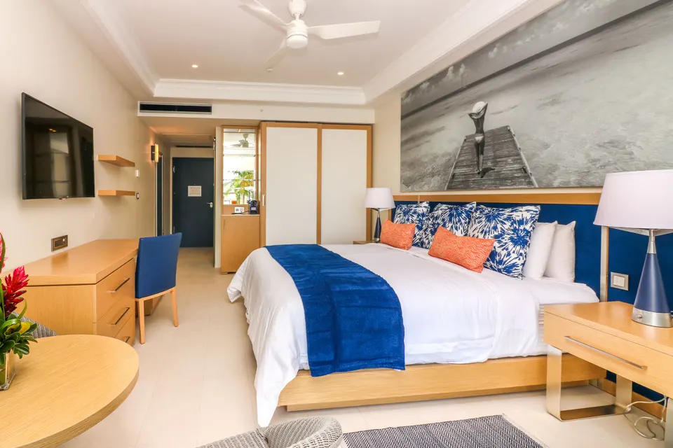 Island View room with king bed, desk, and wall art at Harbor Club St. Lucia.