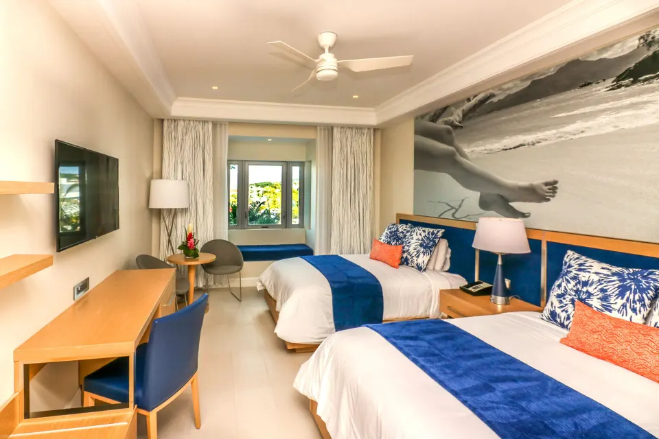 Island View room with two double beds and desk at Harbor Club St. Lucia.