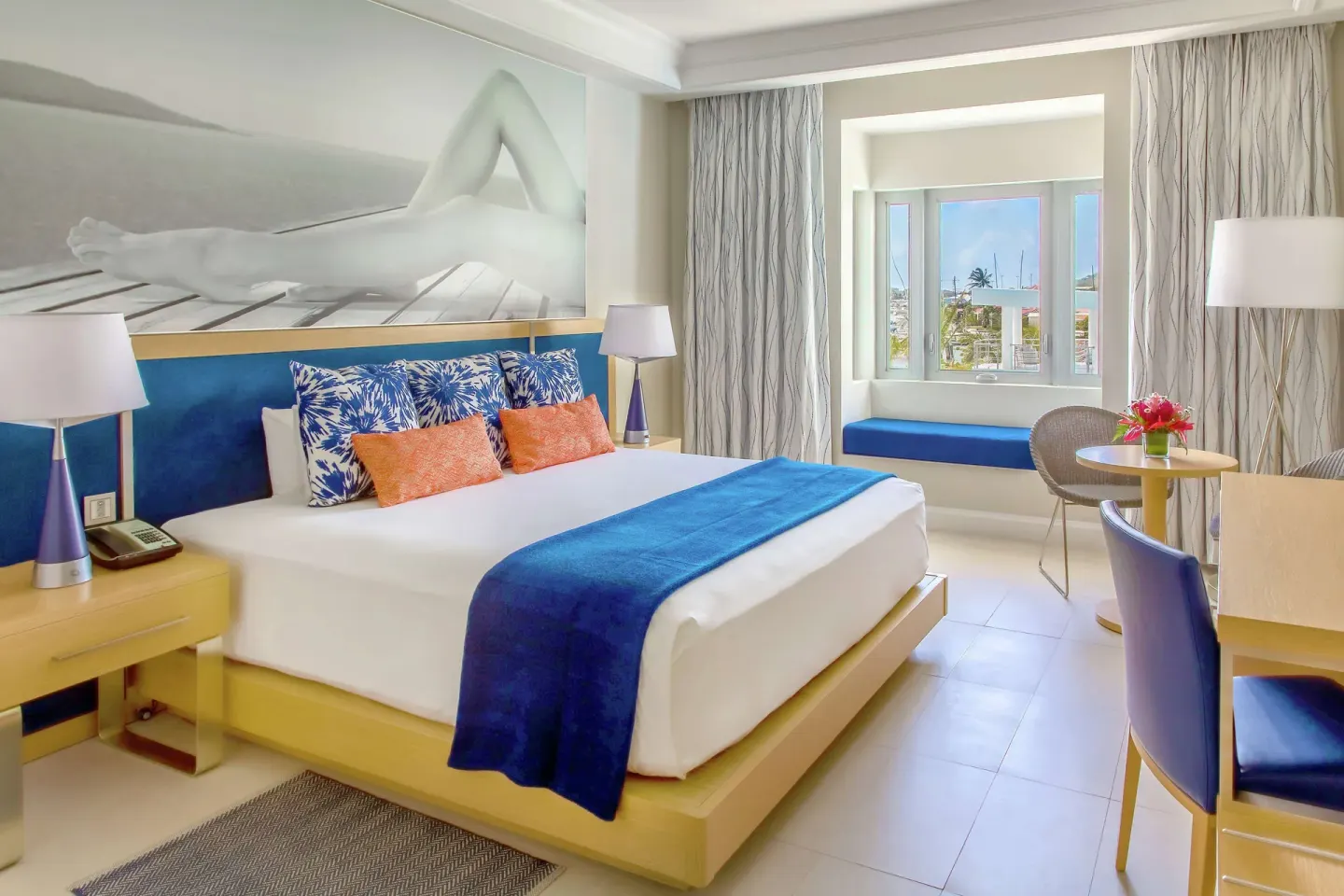 Marina View room with a king bed and window seating at Harbor Club St. Lucia.
