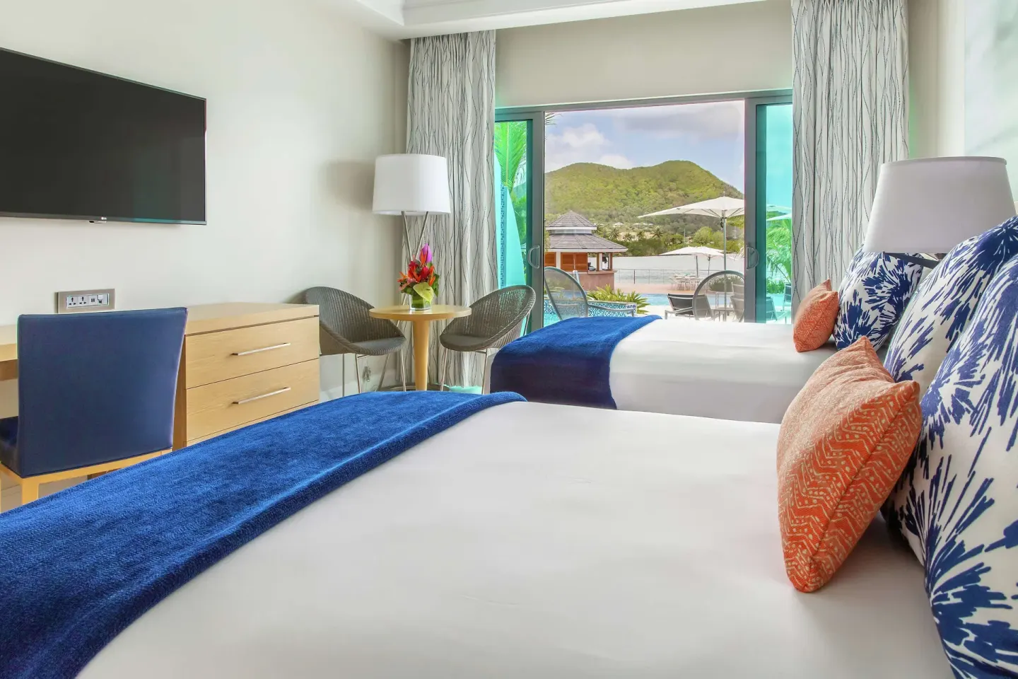 Swim-up double room with two beds and balcony view at Harbor Club St. Lucia.