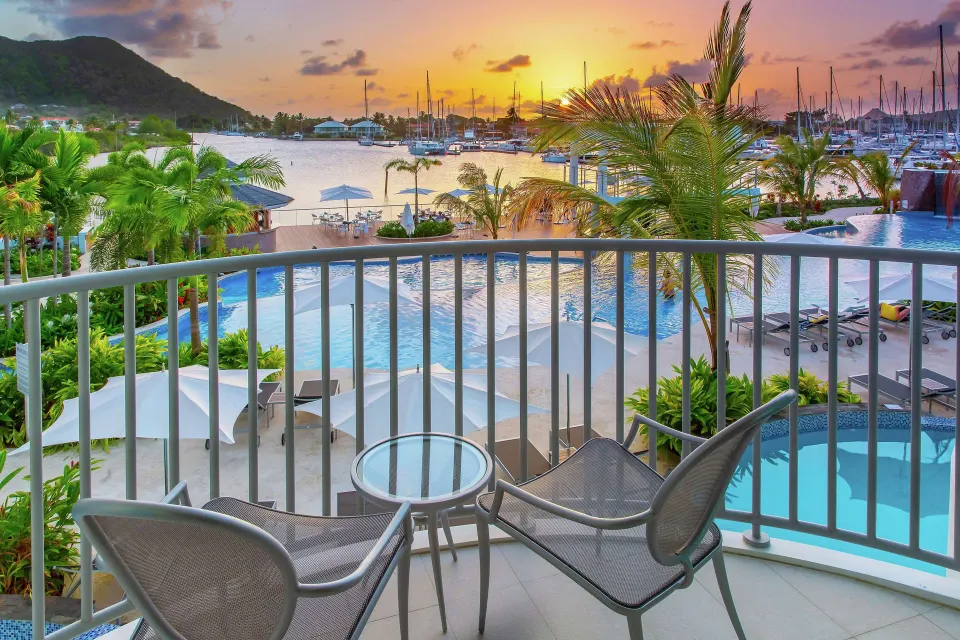 Terrace chairs overlooking the pool and marina at Harbor Club St. Lucia.