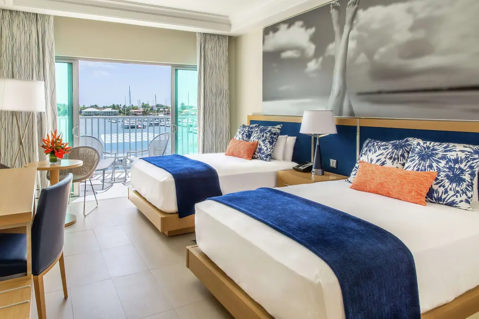Two-bed guest room with marina-facing balcony at Harbor Club St. Lucia.