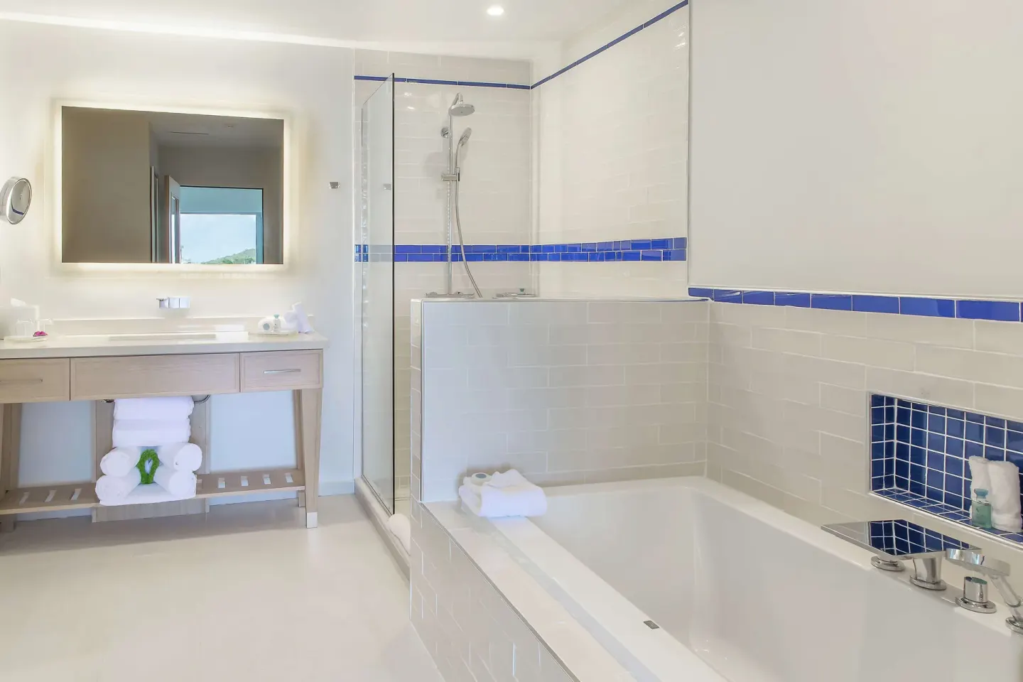 Captain Suite bathroom with tub, glass shower, and vanity at Harbor Club St. Lucia