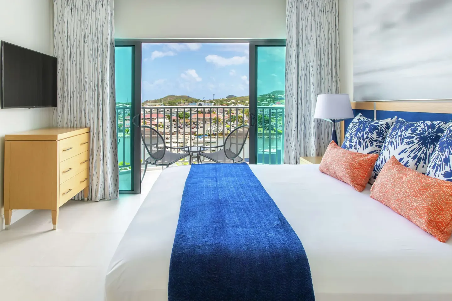 Captain Suite bedroom with king bed and balcony at Harbor Club St. Lucia