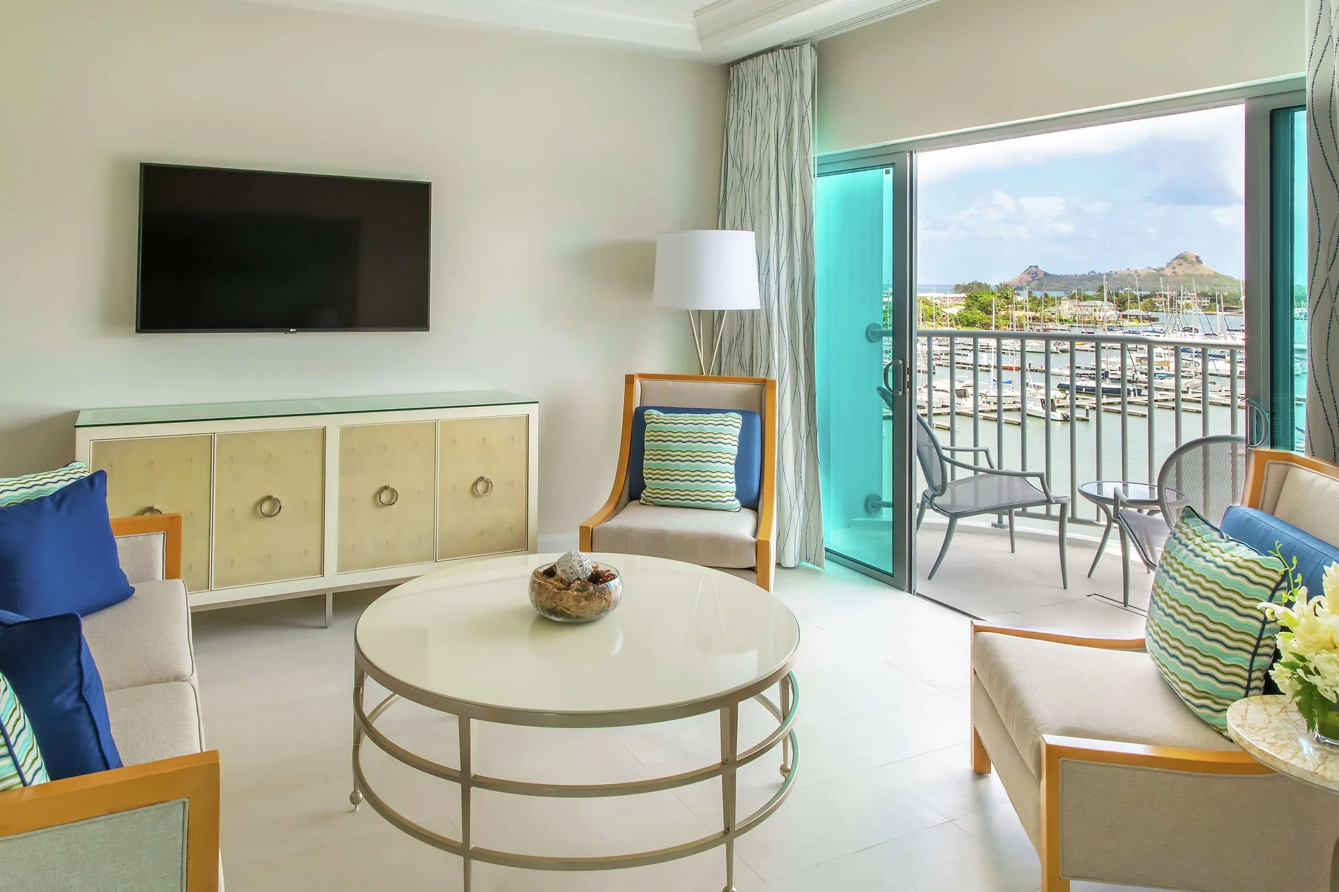 Captain Suite living area with balcony marina view at Harbor Club St. Lucia
