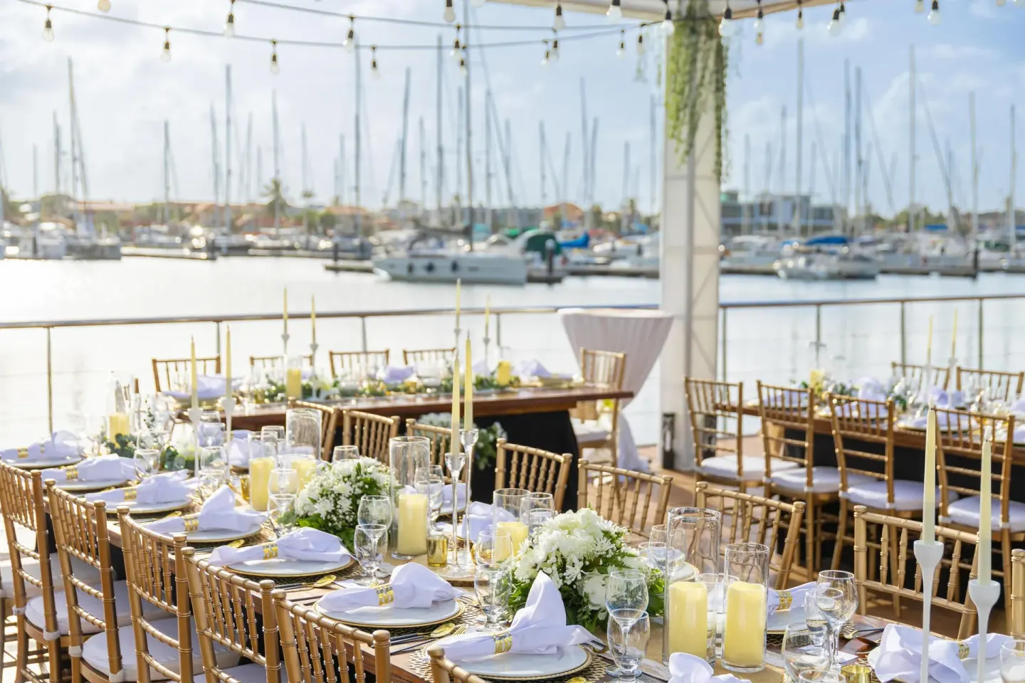 Marina-view event tables set with flowers and candles at Harbor Club St. Lucia.