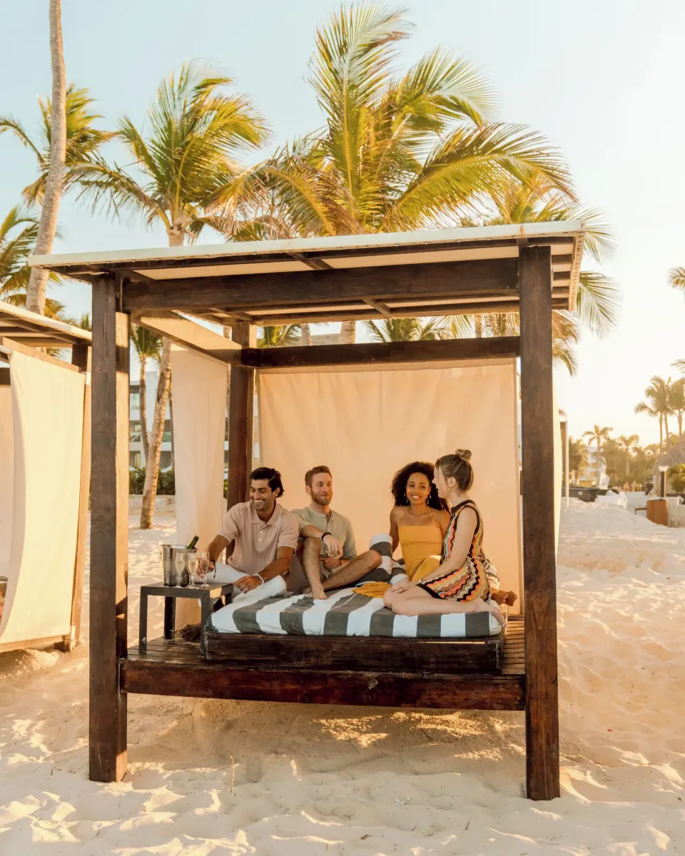 Guests relax on a beach cabana at Hard Rock Hotel & Casino Punta Cana.