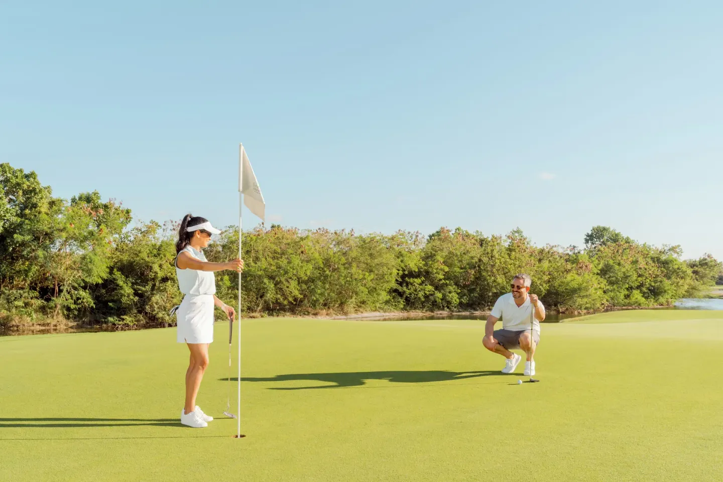Golfers line up a putt on the green at Hard Rock Hotel & Casino Punta Cana.