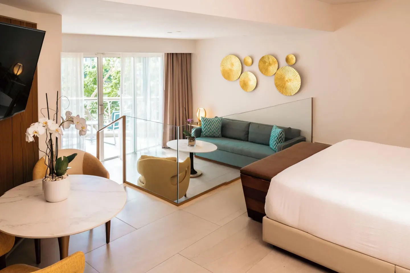 King bed and sunken lounge area in a guest room at Hard Rock Hotel & Casino Punta Cana.