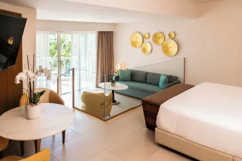 King bed and sunken lounge area in a guest room at Hard Rock Hotel & Casino Punta Cana.
