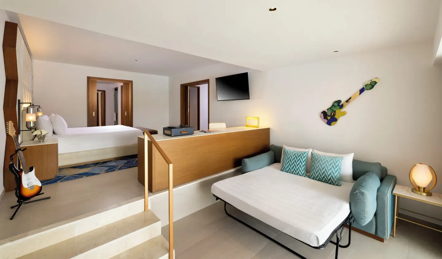 King bed and sofa bed in a split-level suite at Hard Rock Hotel & Casino Punta Cana.