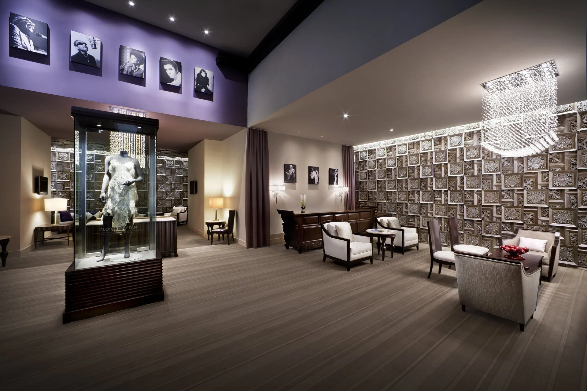 Lounge seating and a costume display case at Hard Rock Hotel & Casino Punta Cana.