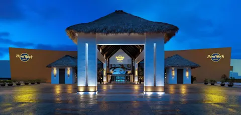 Illuminated resort entrance at dusk at Hard Rock Hotel & Casino Punta Cana.