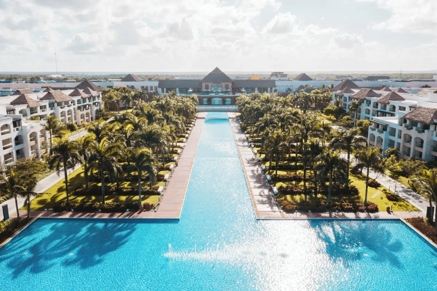 Aerial view of pools, palms, and guest buildings at Hard Rock Hotel & Casino Punta Cana.