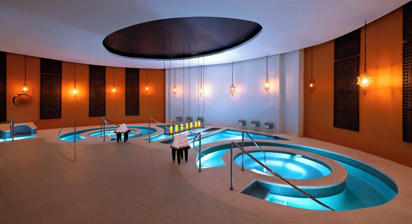 Spa hydrotherapy pools with glowing blue water at Hard Rock Hotel & Casino Punta Cana.