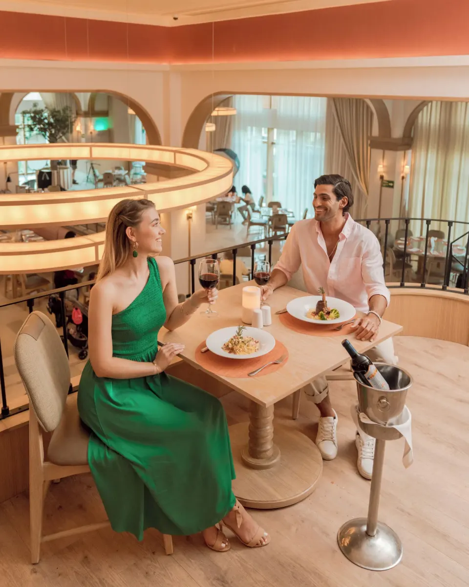 Couple dining on an upper-level balcony at Hard Rock Hotel & Casino Punta Cana.