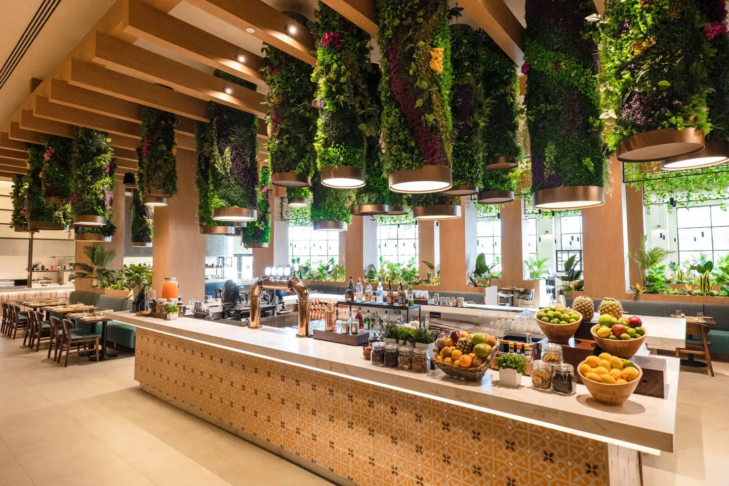 Restaurant bar with hanging greenery and bowls of fruit at Hard Rock Hotel & Casino Punta Cana.