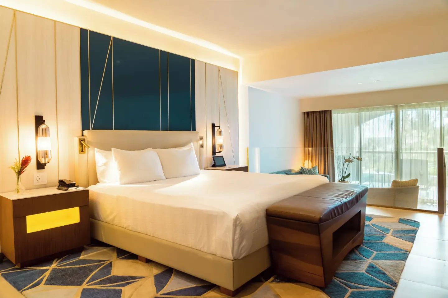 Islander Junior Suite bed and seating area at Hard Rock Hotel & Casino Punta Cana.