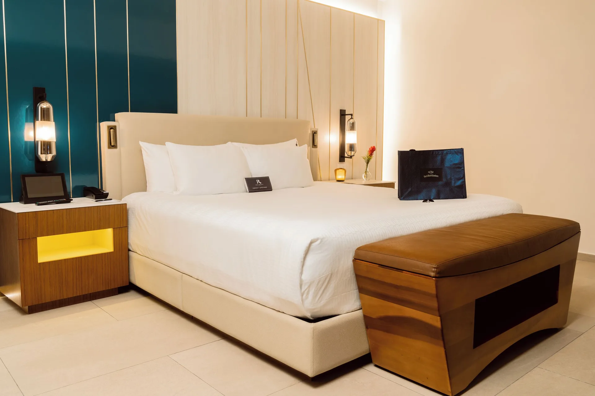 Rock Royalty Caribbean Sand Suite king bed and bench at Hard Rock Hotel & Casino Punta Cana with luxury bedding and upscale rock-inspired décor.