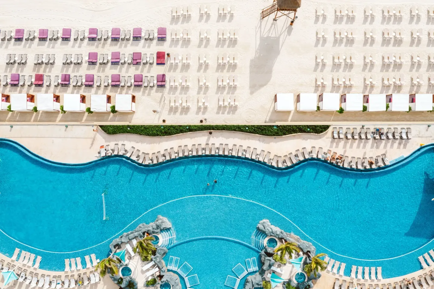 Aerial view of the pool, beach loungers, and cabanas at Hard Rock Hotel Cancun.